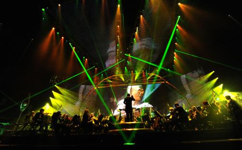 C-3PO onscreen with lights and lasers during Star Wars™: In Concert.