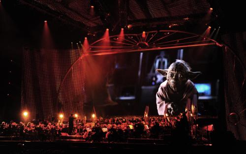 A contemplative Yoda onscreen over the orchestra during Star Wars™: In Concert.